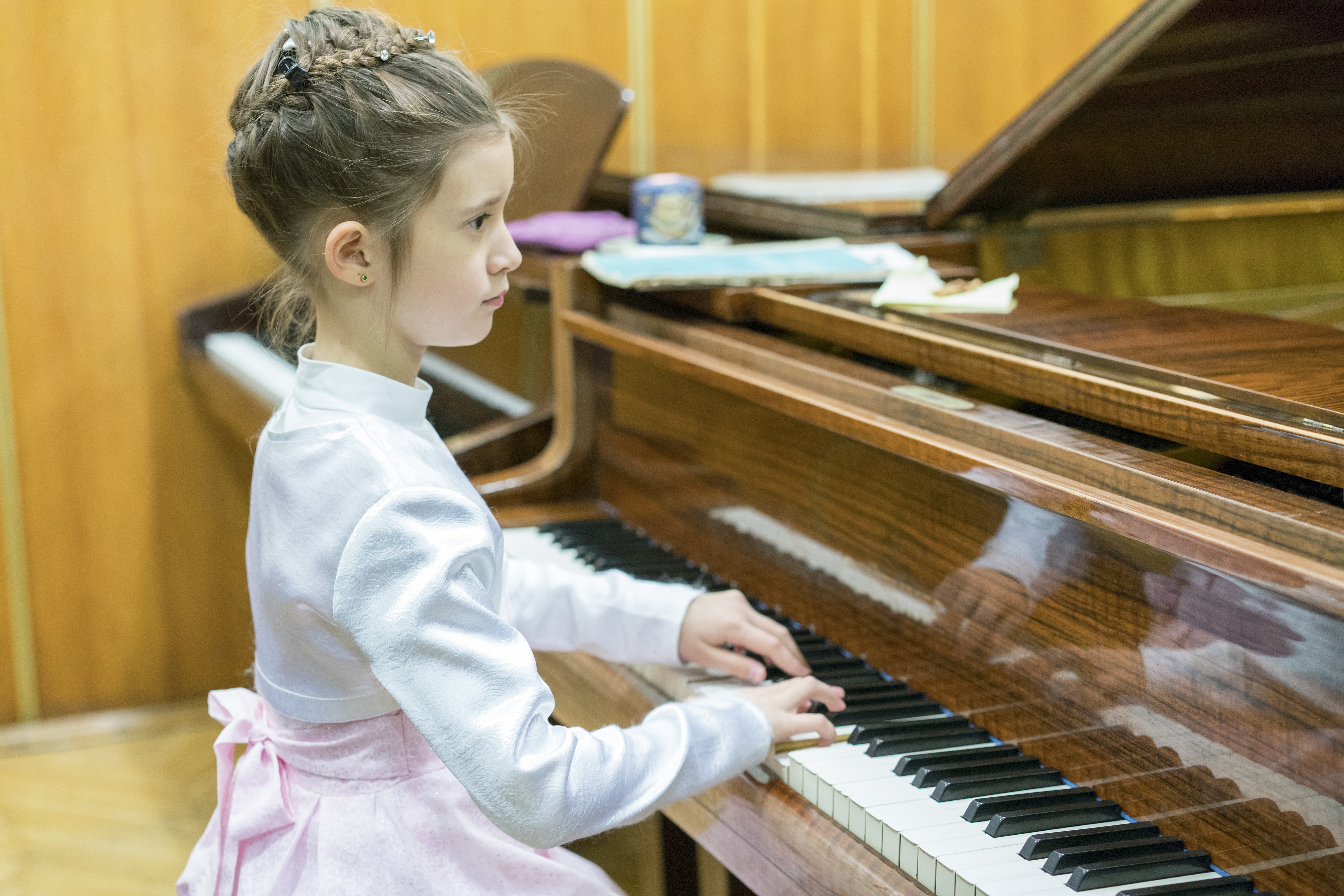 little girl playing the grand piano