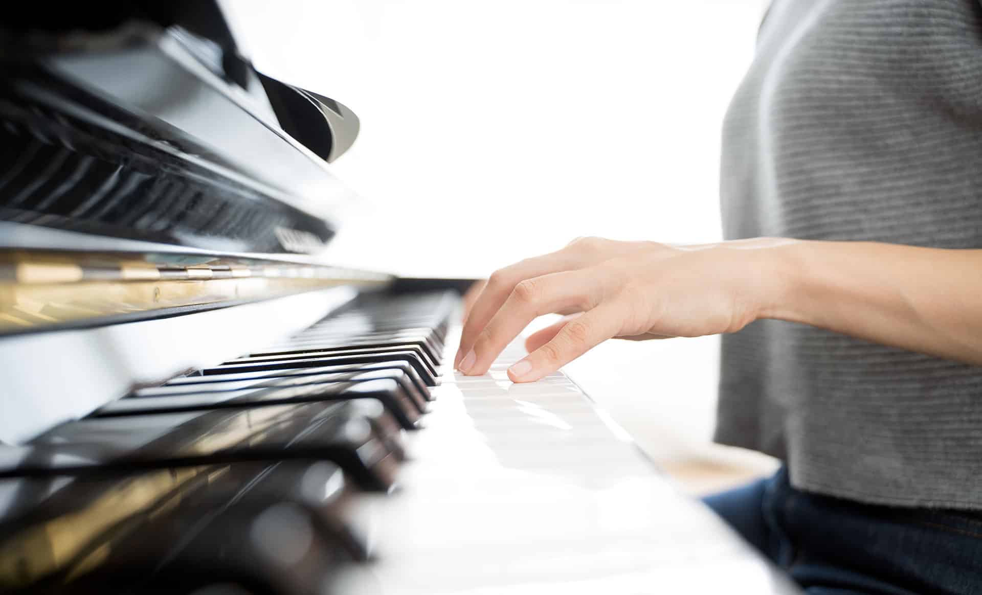Closeup of woman's hand on piano keyboard